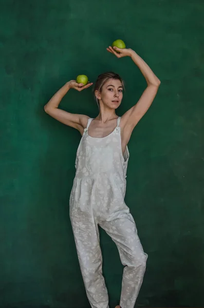 Mujer Joven Traje Blanco Posando Sosteniendo Manzanas Sobre Fondo Pared —  Fotos de Stock