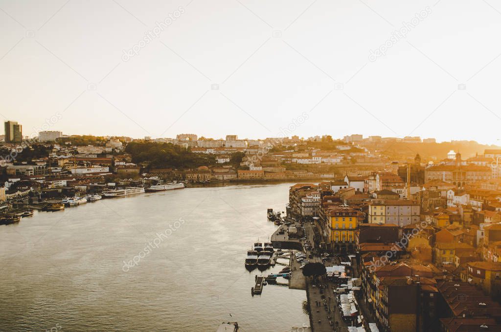beautiful Porto cityscape with red roofs and river while sunset 