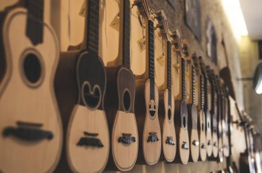 different portuguese guitars on wall  clipart
