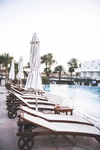 White loungers near pool — Stock Photo, Image