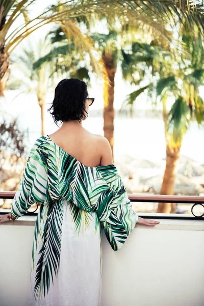 woman looking forward in tropical beach