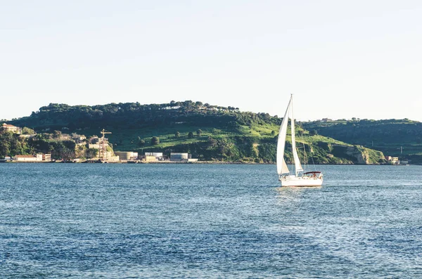 Lisbon landscape with river yacht and mountains