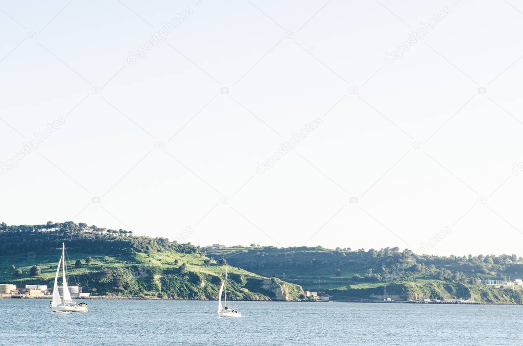 Lisbon landscape with river yacht and mountains