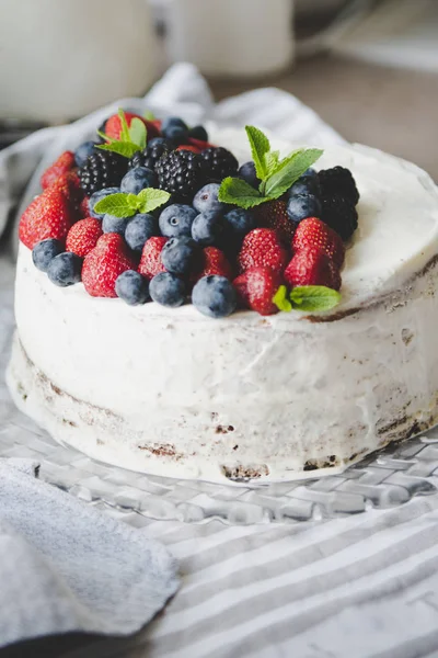 beautiful white cream cheese cake with different summer berries