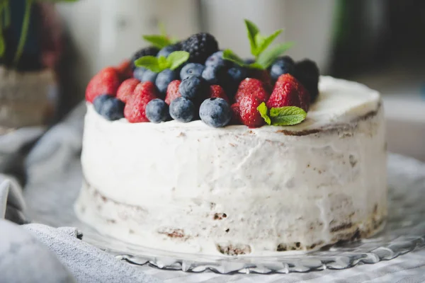 beautiful white cream cheese cake with different summer berries