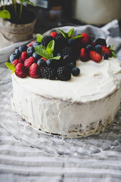 beautiful white cream cheese cake with different summer berries