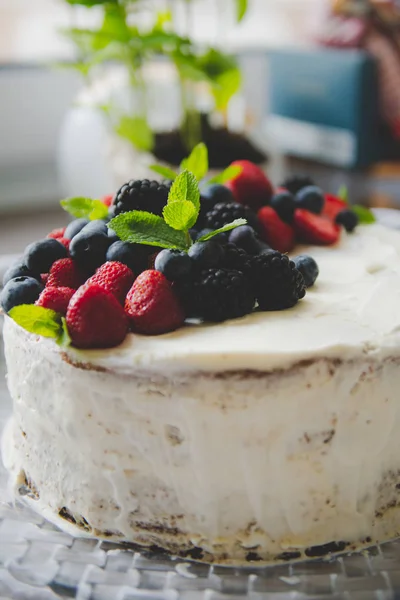 beautiful white cream cheese cake with different summer berries