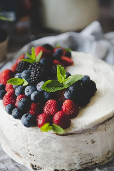 beautiful white cream cheese cake with different summer berries