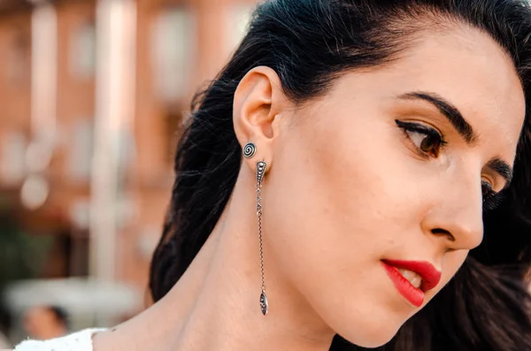 Young woman in national silver earrings, close up — Stock Photo, Image