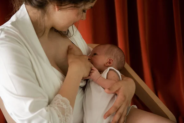 Mujer joven amamantando a su bebé con efecto de grano —  Fotos de Stock