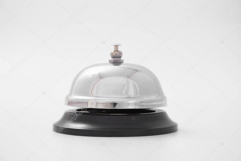 Hand of a woman using a hotel bell isolated