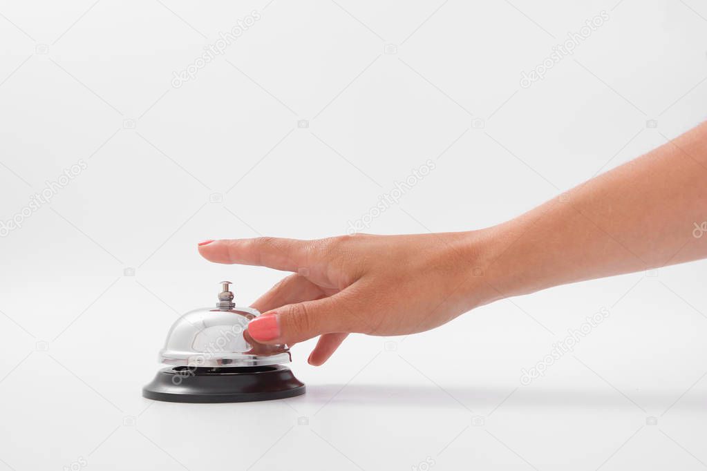 Hand of a woman using a hotel bell isolated