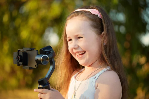 girl with a camera and stabilizer removes