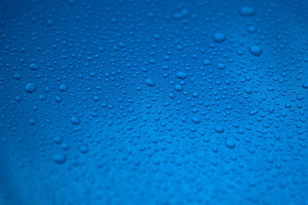 Rain drops on a blue smooth surface