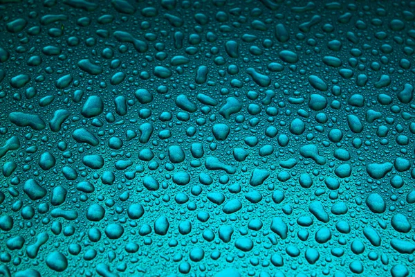 Rain drops on a blue smooth surface