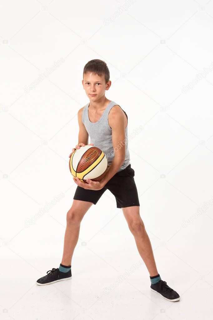 teenager with a basketball on a white background