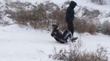 Gomel, Belarus - 1 Aralık 2018: Kış eğlenceli. Çocuklar ebeveynleri ile bir kar tepeye sledging git.