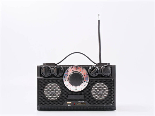 Retro black radio receiver with antenna and speakers.