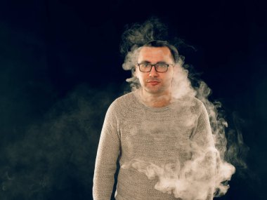 Genç adam elektronik sigara içiyor.