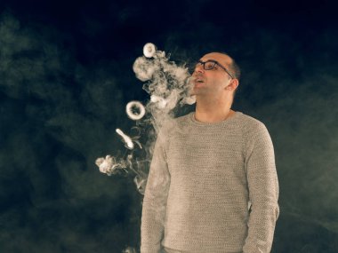 Genç adam elektronik sigara içiyor.