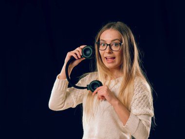 Güzel zevk genç kadın koyu siyah arka plan üzerine kablosuz kulaklık müzik dinleme