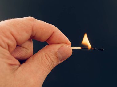 siyah arka plan üzerine elinde yanan kükürt büyükbaş