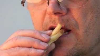 büyük ağız dudaklar. adam yeme patates kızartması.