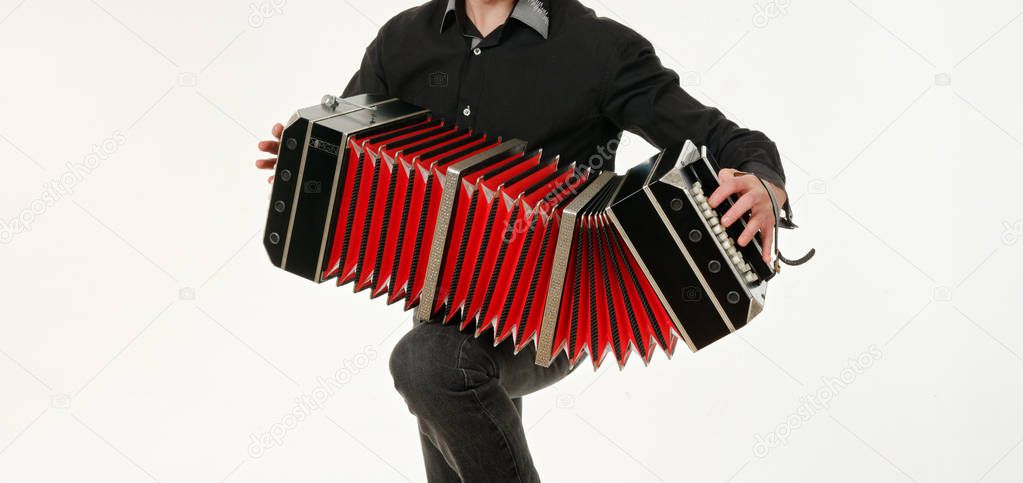 GOMEL, BELARUS - FEBRUARY 14, 2019: a bandoneon musical instrument in the hands of a musician