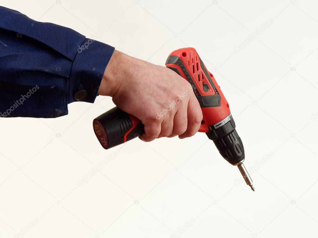 man in workwear holds a drill tool on white background