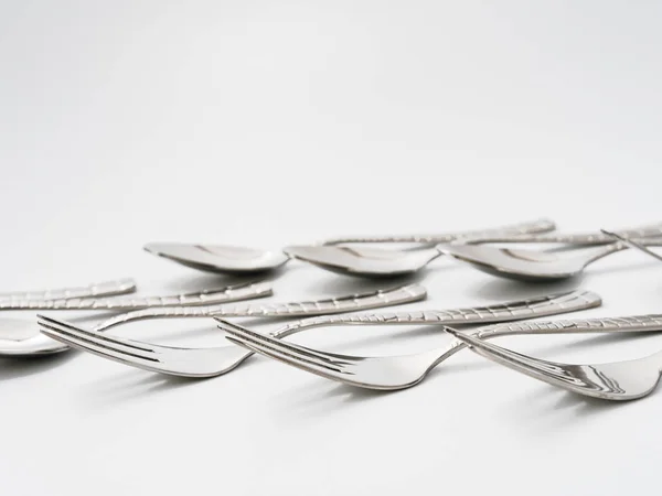 Talheres garfos e colheres em um fundo branco — Fotografia de Stock