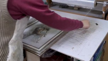 Gomel, Beyaz Rusya - 18 Nisan 2019: Çerçeve atölyesinde çalışan bir işçi çerçeve yapıyor.