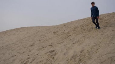 Çocuklar ve gençler beyaz kumda eğlenirler. Parkour