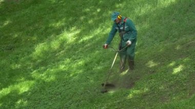 Gomel, Beyaz Rusya - 15 Mayıs 2019: Saray ve park topluluğu Paskevichi. Bir adam çim biçme makinesi ni biçer..
