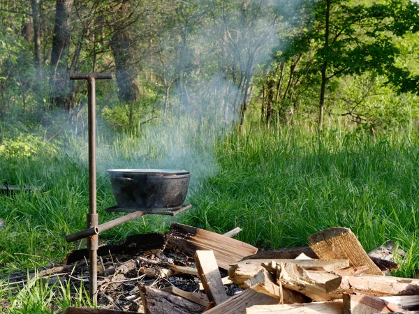 Pot on the fire on a green background. — Stock Photo, Image