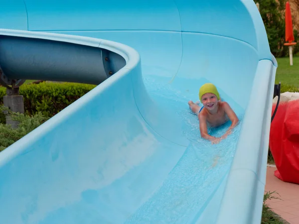 Boy rides water slide rides at the water park — Stock Photo, Image