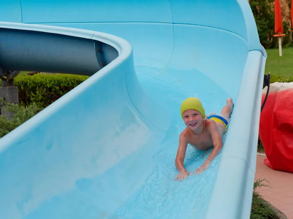 Boy rides water slide rides at the water park — Stock Photo, Image