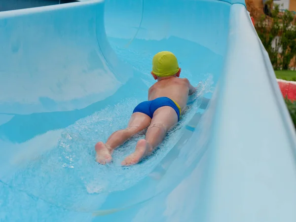 Boy rides water slide rides at the water park — Stock Photo, Image