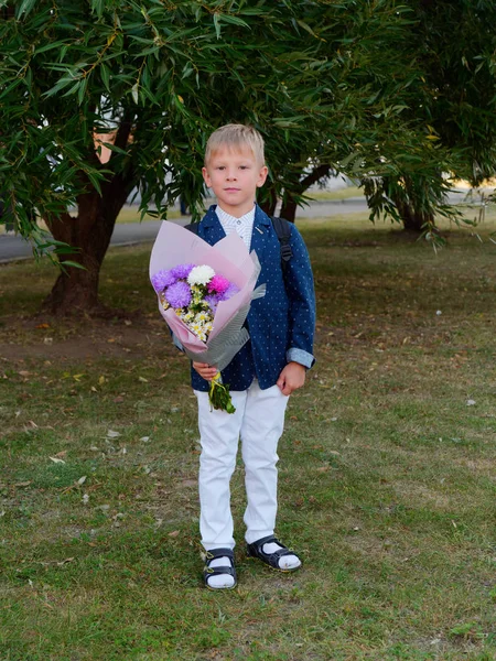 first-year boy with a large bouquet of flowers