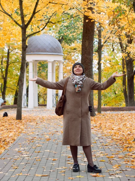 Vacker brunett kvinna i höst gul park — Stockfoto