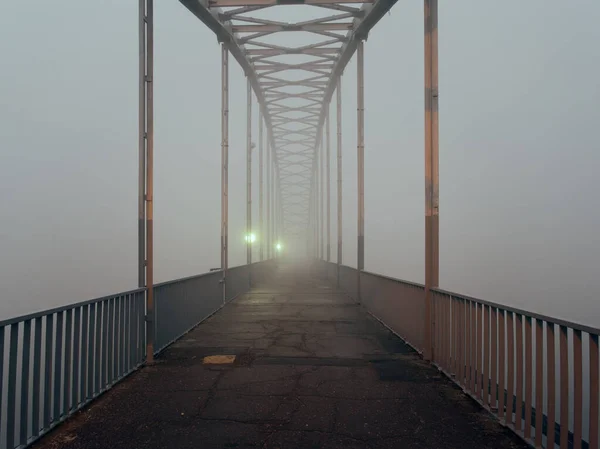 foot bridge in the fog in the fall. Gomel, Belarus