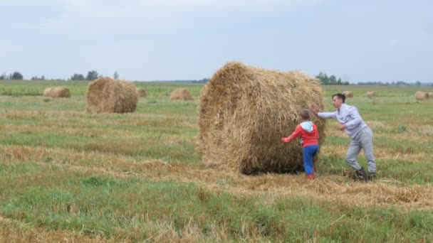 Children Play Bale Straw Field — Stock Video