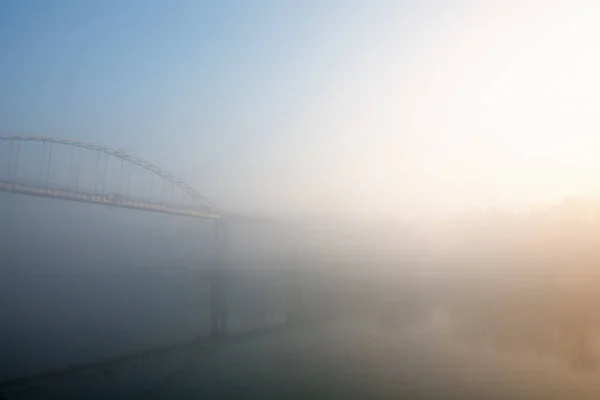 foot bridge in the fog in the fall. Gomel, Belarus 2020