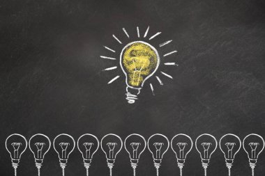 Light bulbs with an idea light bulb on chalkboard