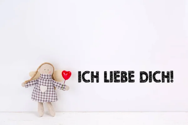 Little angel doll with a balloon red heart and a \'Ich liebe dich\' text. Tranalation: I love you