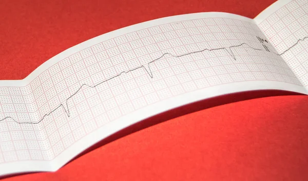 stock image Paper electrocardiogram on a red background, medical concept, banner