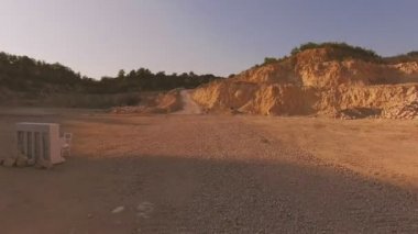 beyaz piyano ve beyaz bir sandalye sarı kum kayalar arka planı üzerinde durmak. İlginç bir hikaye. Havadan görünümü