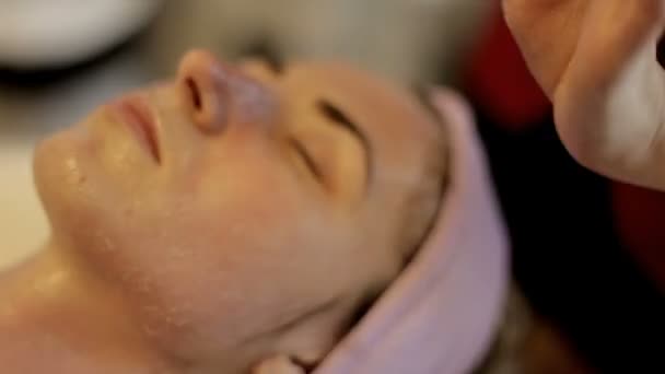 Esthéticienne efface le visage de la fille dans le salon de beauté . — Video