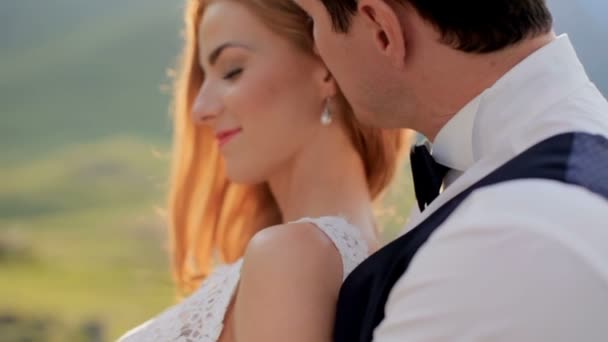 A beautiful bride in the tender embrace of the groom. The concept of a happy married life — Stock Video