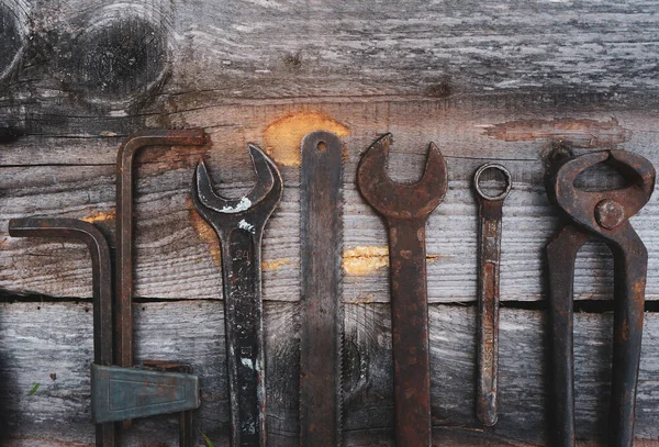 Different repair vintage tools and equipment border on wood background with copy space, top view