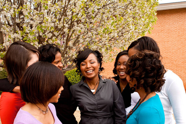 Diverse group of friends talking and laughing.